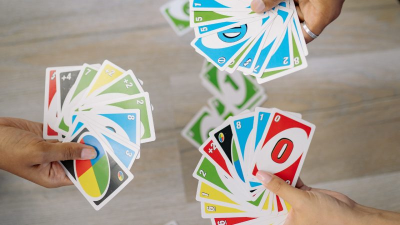 Playing American Card Game Uno, Holding Game Cards in Female Hand
